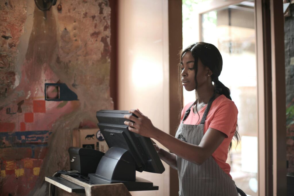 Person using an EPOS system at a store counter for seamless transactions.