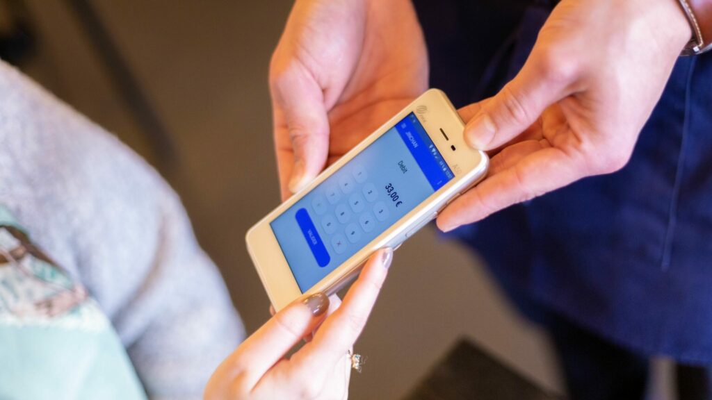 Contactless POS integration showing customer making tap-to-pay transaction at Irish merchant
