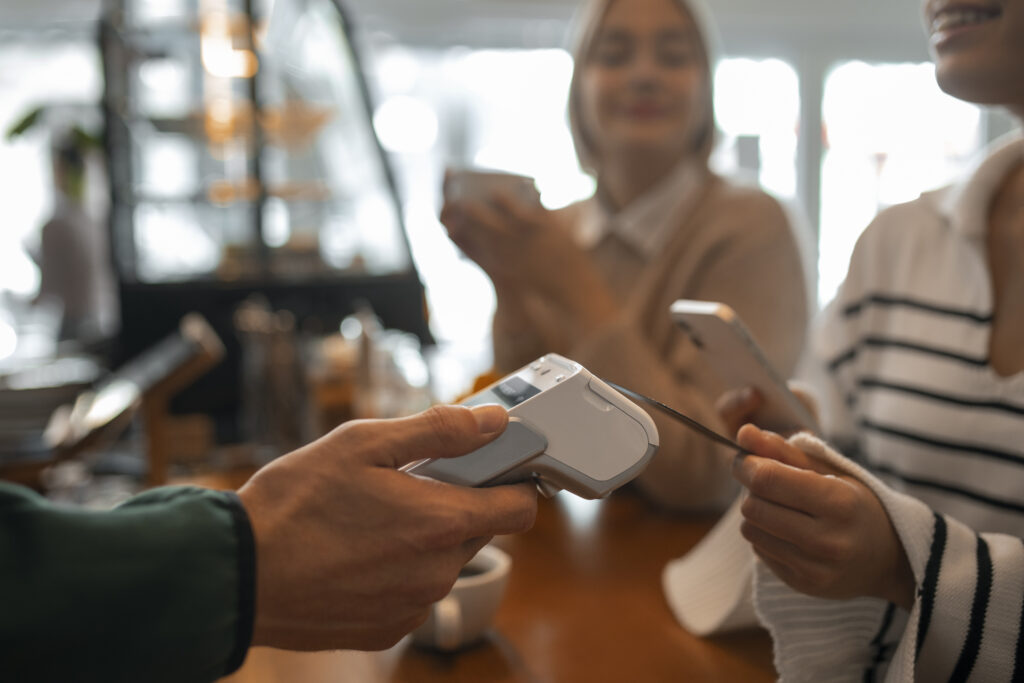 Customer using traditional vs smart card terminal for contactless payment