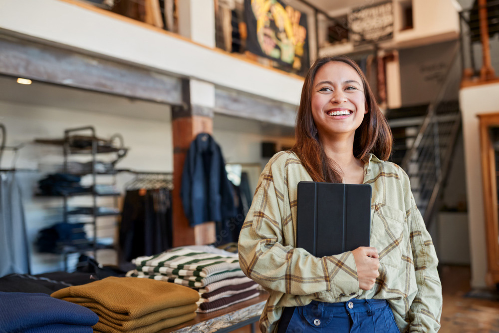 Business owner woman using EPOS tablet for e-commerce payment gateway comparison analytics