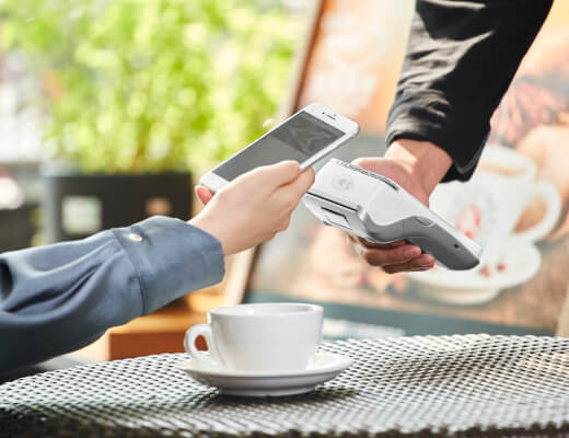 Person making contactless payment under terms analyzed in payment processor contract comparison guide